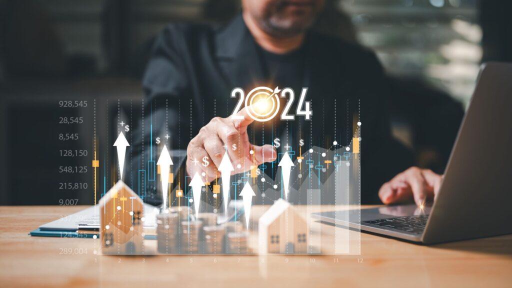 Hand zeigt auf Bildschirm mit Immobilienmarktanalyse 2024