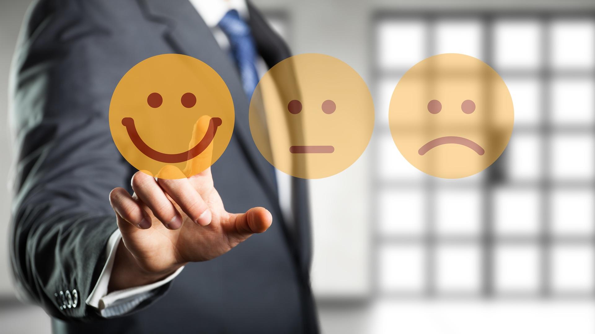 Hand wählt glückliches Smiley als Feedback | Anwalt Arbeitsrecht Bonn